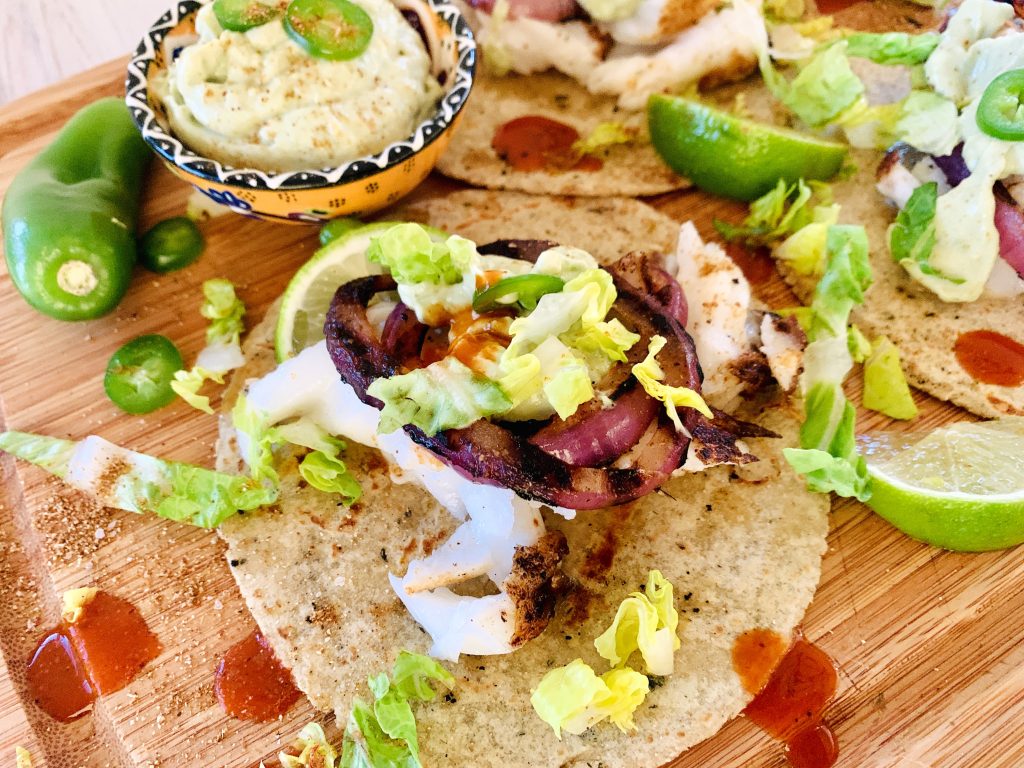 Grilled Sea Bass and Red Onion Tacos with Avocado Crema Recipe